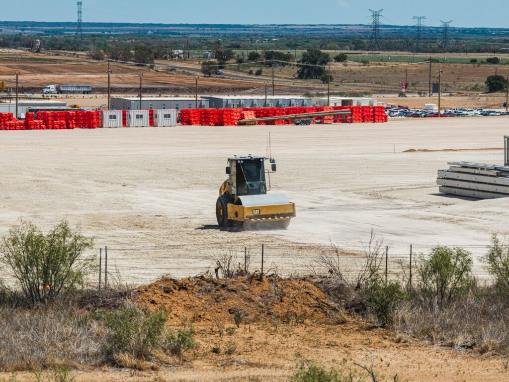 Smooth drum roller finish grading a building pad for a data center campus in Haskell, Texas
